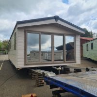 Static caravan getting loaded onto a flatbed