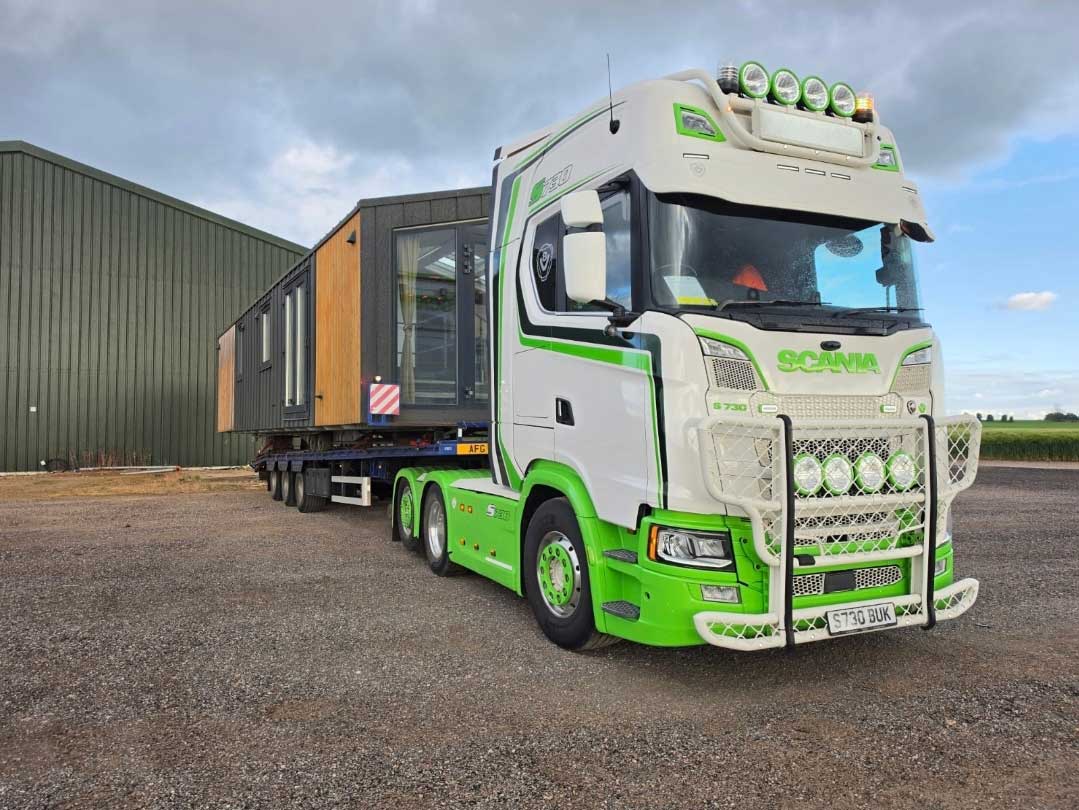 green lory carrying static caravan